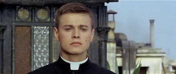 Movie still from “Yesterday, Today and Tomorrow” (1963), directed by Vittorio De Sica – A young man wearing a priest's collar; Close Up shot, Low angle