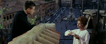 Movie still from “Yesterday, Today and Tomorrow” (1963), directed by Vittorio De Sica – Two people standing on a balcony overlooking a city; Medium shot, Over the shoulder angle