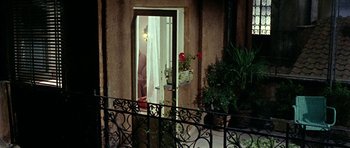 Movie still from “Yesterday, Today and Tomorrow” (1963), directed by Vittorio De Sica – A view of a balcony from outside the house; Wide shot, High angle