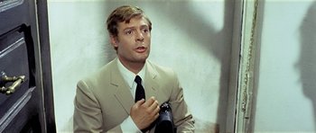 Movie still from “Yesterday, Today and Tomorrow” (1963), directed by Vittorio De Sica – A man wearing a suit and tie holding a camera; Close Up shot, Over the shoulder angle