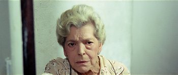 Movie still from “Yesterday, Today and Tomorrow” (1963), directed by Vittorio De Sica – An older woman with a frowning look on her face; Close Up shot, Low angle