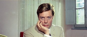 Movie still from “Yesterday, Today and Tomorrow” (1963), directed by Vittorio De Sica – A person wearing a suit and holding his hand to his face; Close Up shot, High angle