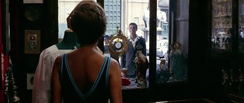 Movie still from “Yesterday, Today and Tomorrow” (1963), directed by Vittorio De Sica – A woman standing in front of a window looking at a man; Medium shot, Over the shoulder angle