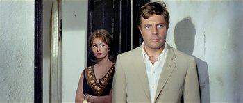 Movie still from “Yesterday, Today and Tomorrow” (1963), directed by Vittorio De Sica – A man and a woman standing next to each other; Medium shot, Over the shoulder angle