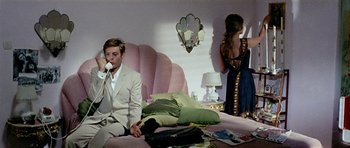 Movie still from “Yesterday, Today and Tomorrow” (1963), directed by Vittorio De Sica – A man sitting on a couch talking on the phone; Medium shot, High angle