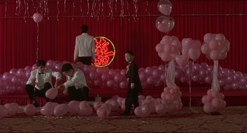 Movie still from “Yi Yi” (2000), directed by Edward Yang – A group of people standing next to a bunch of pink balloons; Wide shot, High angle