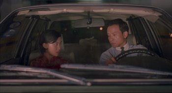 Movie still from “Yi Yi” (2000), directed by Edward Yang – A man and a woman sitting in the back seat of a car; Medium shot, Over the shoulder angle