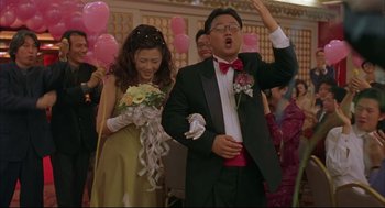 Movie still from “Yi Yi” (2000), directed by Edward Yang – A man and a woman in formal wear holding hands; Medium shot, Low angle