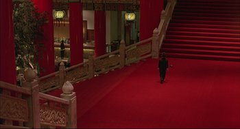 Movie still from “Yi Yi” (2000), directed by Edward Yang – A man walking down a red carpet in a building; Extreme Wide shot, High angle