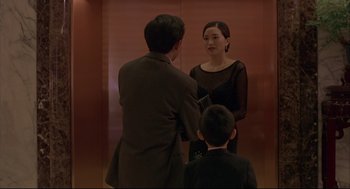 Movie still from “Yi Yi” (2000), directed by Edward Yang – A man and a woman in front of an elevator; Medium shot, Over the shoulder angle