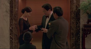 Movie still from “Yi Yi” (2000), directed by Edward Yang – Two men and a woman are exchanging wedding rings; Medium shot, Over the shoulder angle