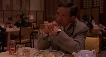 Movie still from “Yi Yi” (2000), directed by Edward Yang – A man sitting at a table with a plate of food; Medium shot, High angle