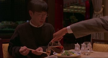 Movie still from “Yi Yi” (2000), directed by Edward Yang – A man pouring a bowl of sauce onto a plate; Medium shot, Over the shoulder angle