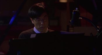 Movie still from “Yi Yi” (2000), directed by Edward Yang – A man sitting in front of a computer monitor; Close Up shot, High angle