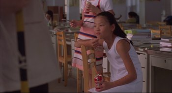 Movie still from “Yi Yi” (2000), directed by Edward Yang – A girl sitting on a chair in front of a woman; Close Up shot, High angle