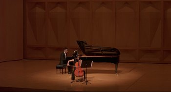 Movie still from “Yi Yi” (2000), directed by Edward Yang – A man and a woman are playing music in front of a grand piano; Extreme Wide shot, High angle