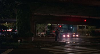Movie still from “Yi Yi” (2000), directed by Edward Yang – A person standing on a street corner at night; Extreme Wide shot, Low angle