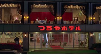 Movie still from “Yi Yi” (2000), directed by Edward Yang – People are sitting at tables outside of a japanese restaurant; Extreme Wide shot, High angle