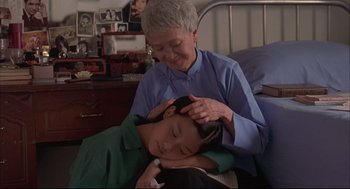 Movie still from “Yi Yi” (2000), directed by Edward Yang – An older woman and a young boy are in a bed; Medium shot, High angle