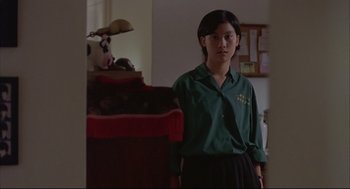Movie still from “Yi Yi” (2000), directed by Edward Yang – A person standing in a room with a dog; Medium shot, Low angle