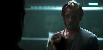 Movie still from “You” (2018), created by Sera Gamble – A man in a dark room holding a cup of coffee; Close Up shot, Over the shoulder angle