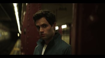 Movie still from “You” (2018), created by Sera Gamble – A man in a green jacket is looking at the camera; Close Up shot, Over the shoulder angle