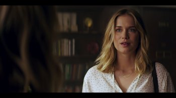 Movie still from “You” (2018), created by Sera Gamble – A beautiful young woman with blonde hair standing next to a bookshelf; Close Up shot, Over the shoulder angle