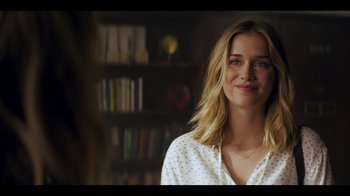 Movie still from “You” (2018), created by Sera Gamble – A beautiful young lady smiling for the camera; Close Up shot, Over the shoulder angle