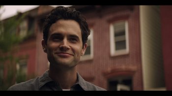 Movie still from “You” (2018), created by Sera Gamble – A person smiling for a picture; Close Up shot, Over the shoulder angle