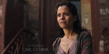 Movie still from “You” (2018), created by Sera Gamble – A person wearing a dress; Close Up shot, Over the shoulder angle