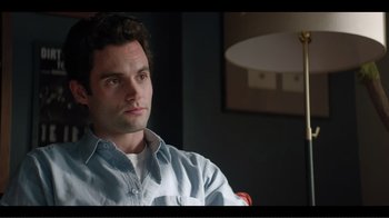 Movie still from “You” (2018), created by Sera Gamble – A person sitting in a chair; Close Up shot, Over the shoulder angle