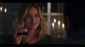 Movie still from “You” (2018), created by Sera Gamble – A woman holding a glass of red wine in her right hand; Close Up shot, Over the shoulder angle