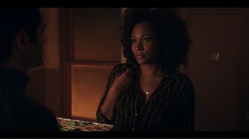 Movie still from “You” (2018), created by Sera Gamble – A woman sitting at a table in front of a laptop; Close Up shot, Over the shoulder angle