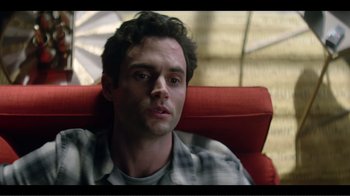 Movie still from “You” (2018), created by Sera Gamble – A person sitting in a chair; Close Up shot, High angle