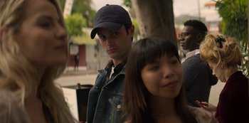 Movie still from “You” (2018), created by Sera Gamble – A man and a woman standing next to each other on the street; Close Up shot, Over the shoulder angle