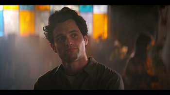 Movie still from “You” (2018), created by Sera Gamble – A person wearing a brown shirt; Close Up shot, Over the shoulder angle