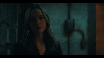 Movie still from “You” (2018), created by Sera Gamble – A woman in a black shirt is in a dark room; Close Up shot, Over the shoulder angle