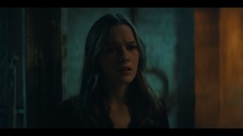 Movie still from “You” (2018), created by Sera Gamble – A woman with long dark hair stares into the distance; Close Up shot, Over the shoulder angle