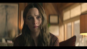 Movie still from “You” (2018), created by Sera Gamble – A woman with long brown hair is staring at the camera; Close Up shot, Over the shoulder angle