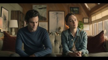 Movie still from “You” (2018), created by Sera Gamble – A man and a woman sitting next to each other on a couch; Medium shot, Over the shoulder angle