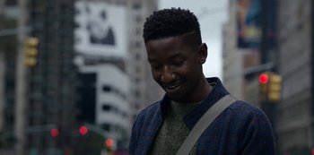 Movie still from “Archive 81” (2022), created by Rebecca Sonnenshine – A young man is standing on the sidewalk; Close Up shot, Over the shoulder angle