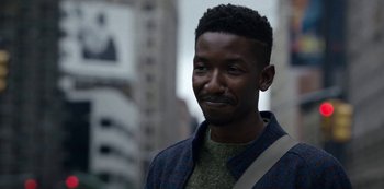 Movie still from “Archive 81” (2022), created by Rebecca Sonnenshine – A person wearing a jacket; Close Up shot, Over the shoulder angle