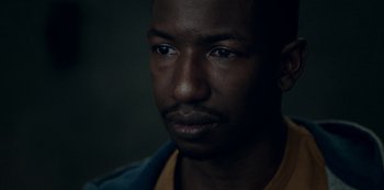 Movie still from “Archive 81” (2022), created by Rebecca Sonnenshine – A man's face in the dark; Close Up shot, Over the shoulder angle