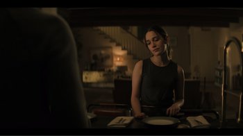 Movie still from “You” (2018), created by Sera Gamble – A woman sitting at a table in front of a mirror; Medium shot, Over the shoulder angle
