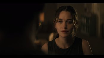 Movie still from “You” (2018), created by Sera Gamble – A young woman is looking into the camera; Close Up shot, Over the shoulder angle