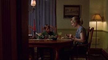 Movie still from “You Can Count on Me” (2000), directed by Kenneth Lonergan – Two people sitting at a table eating food; Medium shot, Over the shoulder angle