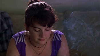 Movie still from “You Can Count on Me” (2000), directed by Kenneth Lonergan – A woman sitting in front of a wall with smoke coming out of her mouth; Close Up shot, Overhead angle