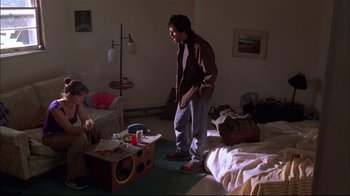 Movie still from “You Can Count on Me” (2000), directed by Kenneth Lonergan – A man standing next to a bed in a room; Wide shot, High angle