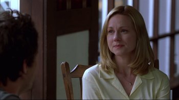 Movie still from “You Can Count on Me” (2000), directed by Kenneth Lonergan – A woman sitting on a chair in front of a window; Close Up shot, Over the shoulder angle