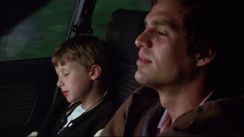 Movie still from “You Can Count on Me” (2000), directed by Kenneth Lonergan – A man and a boy sitting in the back seat of a car; Close Up shot, Low angle
